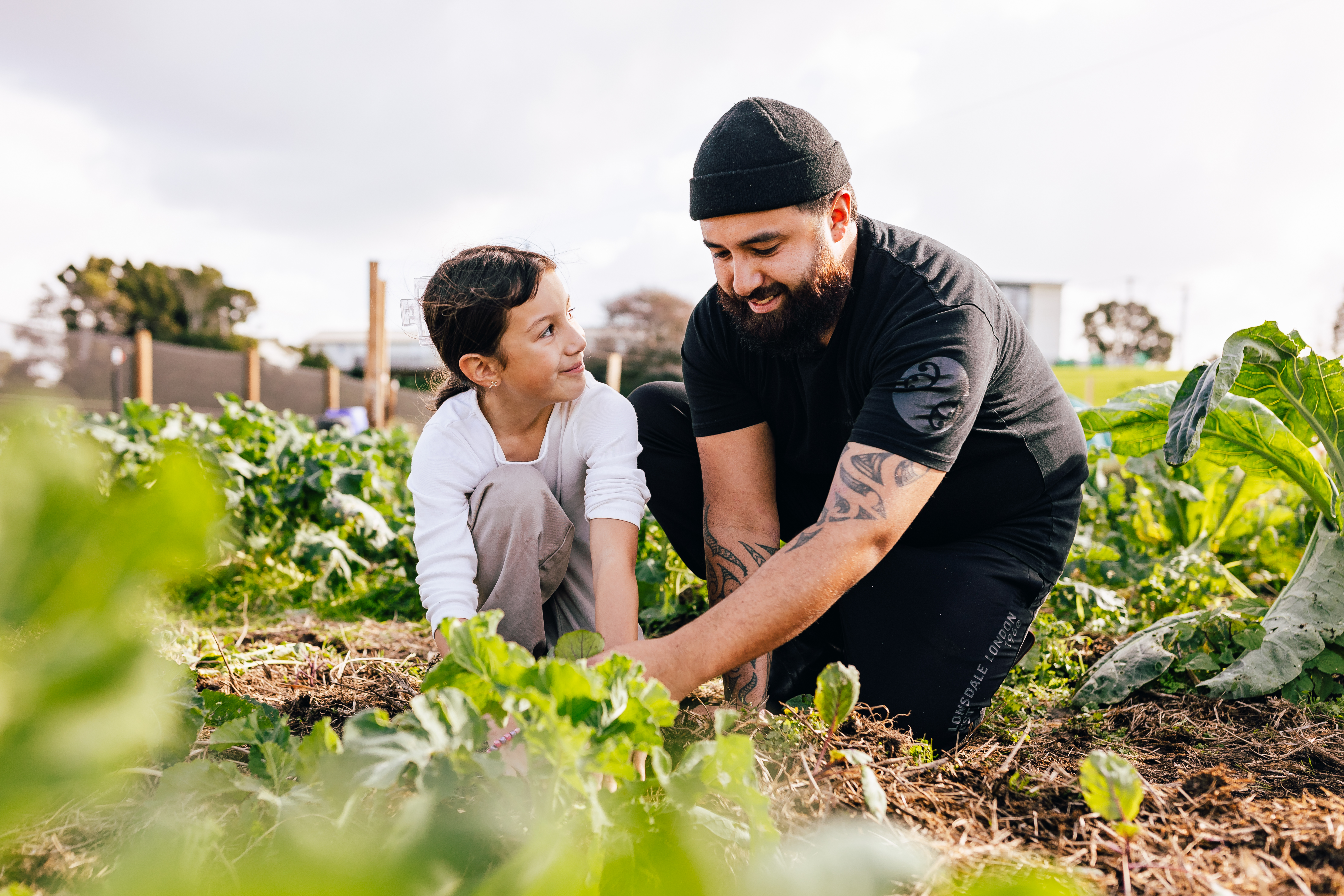 Father and daughter plant crops together at Ngāti Whātua Ōrākei Pourewa Nursery